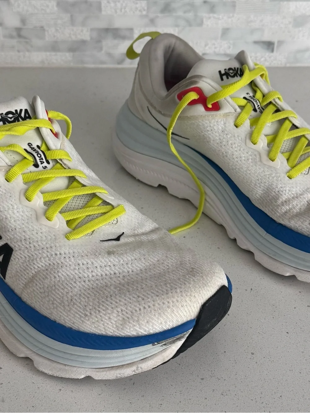Hoka White Running Shoes with Neon Yellow Laces and Blue Accents